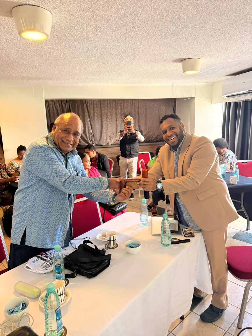 Indigenous Papuan scholars and Vanuatu civic delegates exchanging documents during the Papua Movement forum
