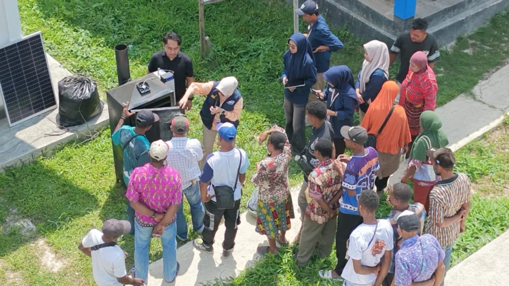 Visitors gathered around equipment on a lawn during a farming demonstration.