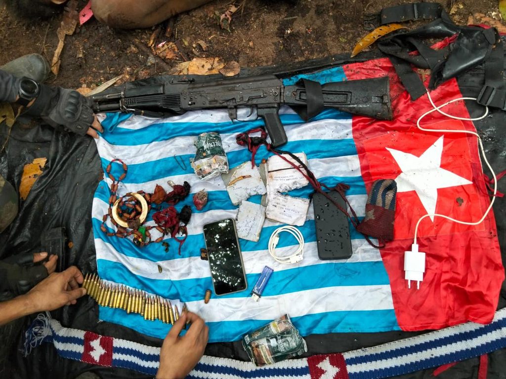 Confiscated AK-101 rifle and ammunition displayed on the Morning Star flag