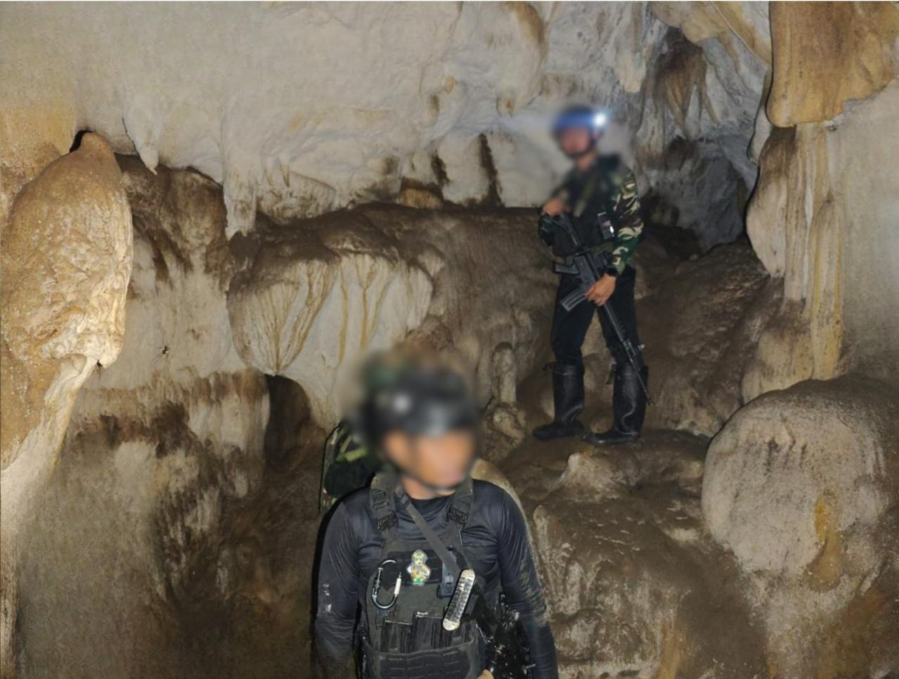 Indonesian soldiers inside a limestone cave in Maybrat, Southwest Papua