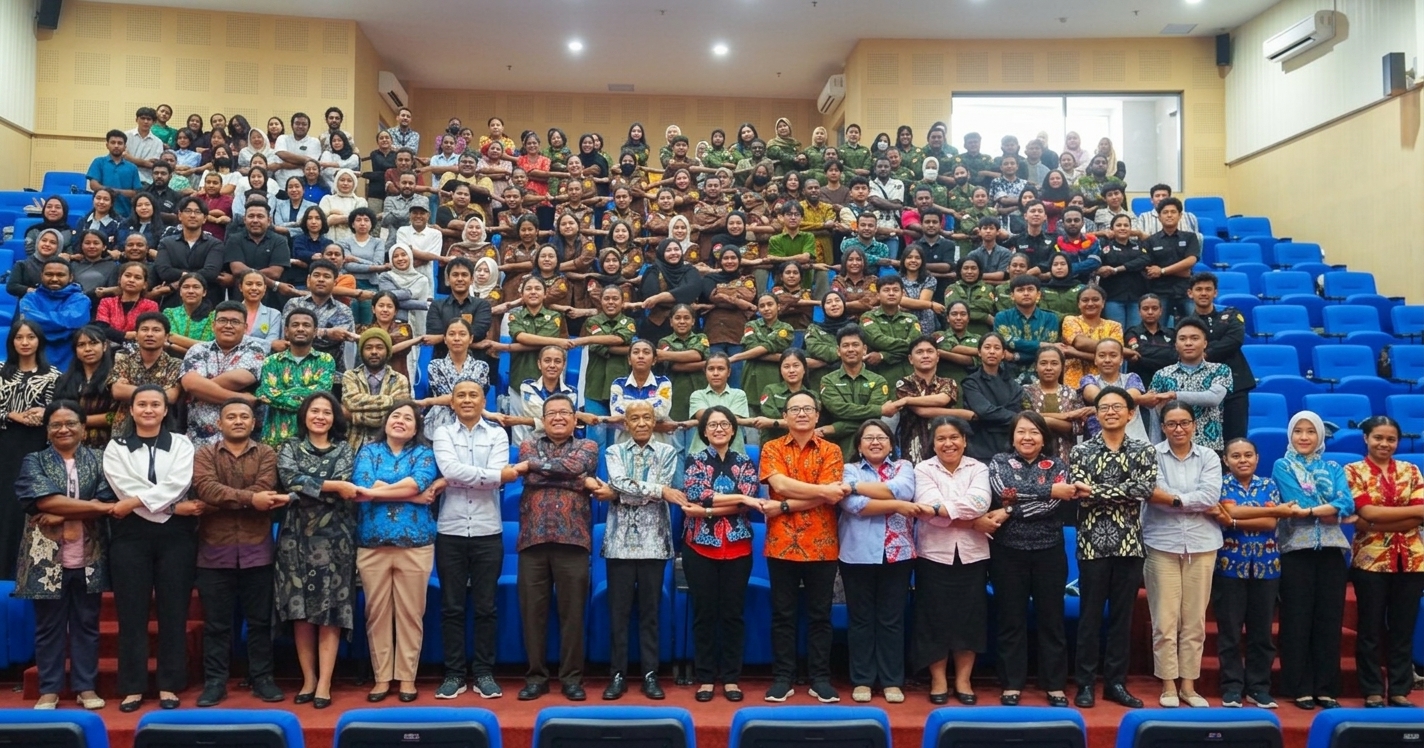 Large group of participants posing in rows in an auditorium during a dialogue event.