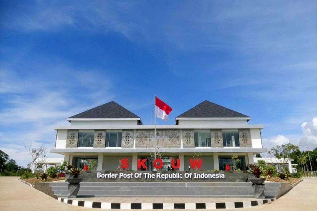 Indonesian border post building with the national flag in front.