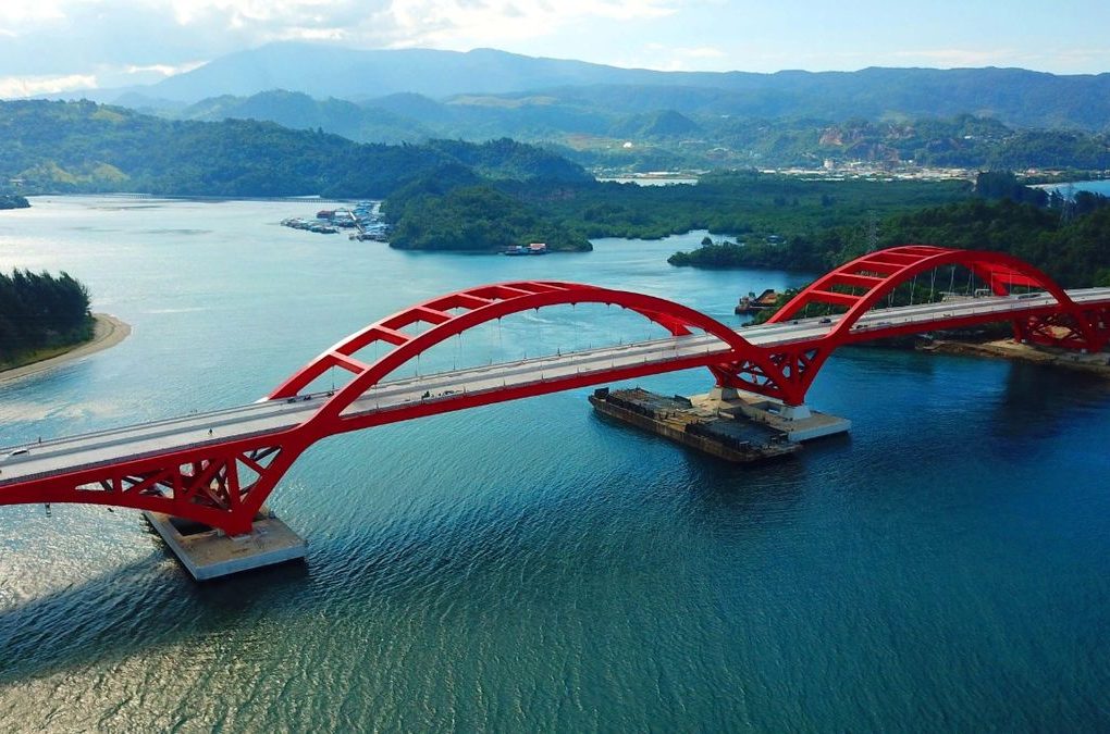 Red arch bridge over a bay near Jayapura.