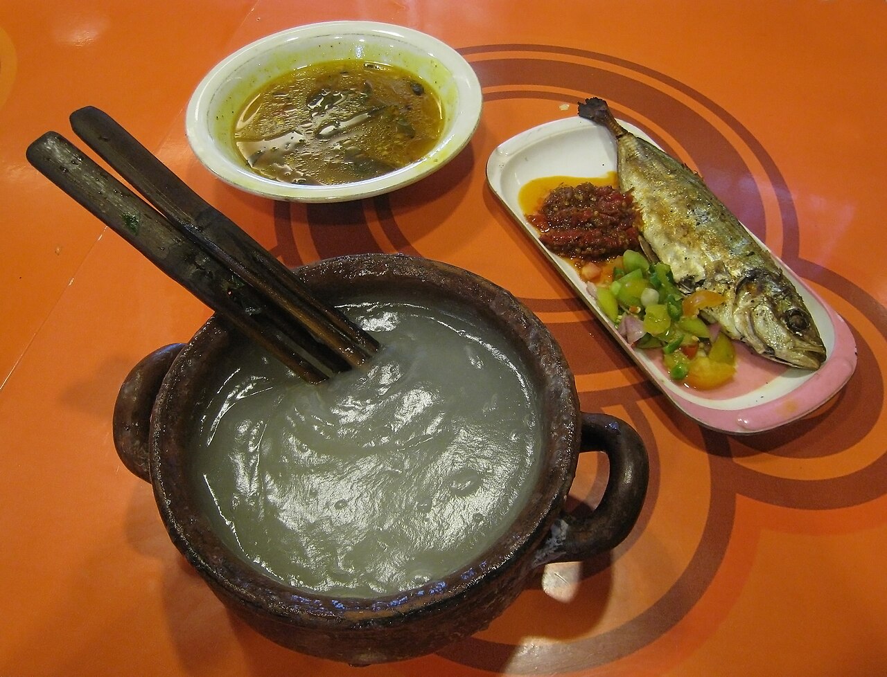 Papuan food: papeda sago porridge with yellow fish soup and grilled fish